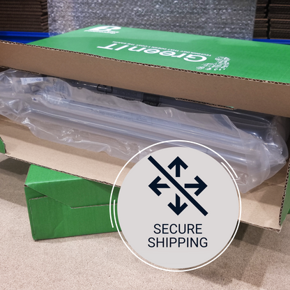 A Greenlit product box with a clear plastic-wrapped item inside, photographed on a carpeted floor. A large circular overlay reads 'SECURE SHIPPING' with arrows and a slash through them.